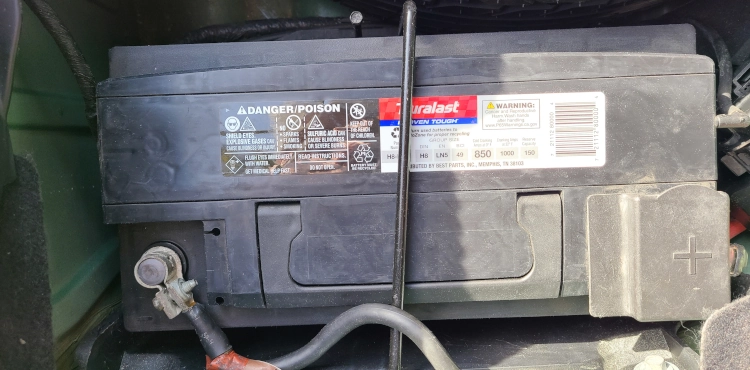 Technician checking a vehicle battery